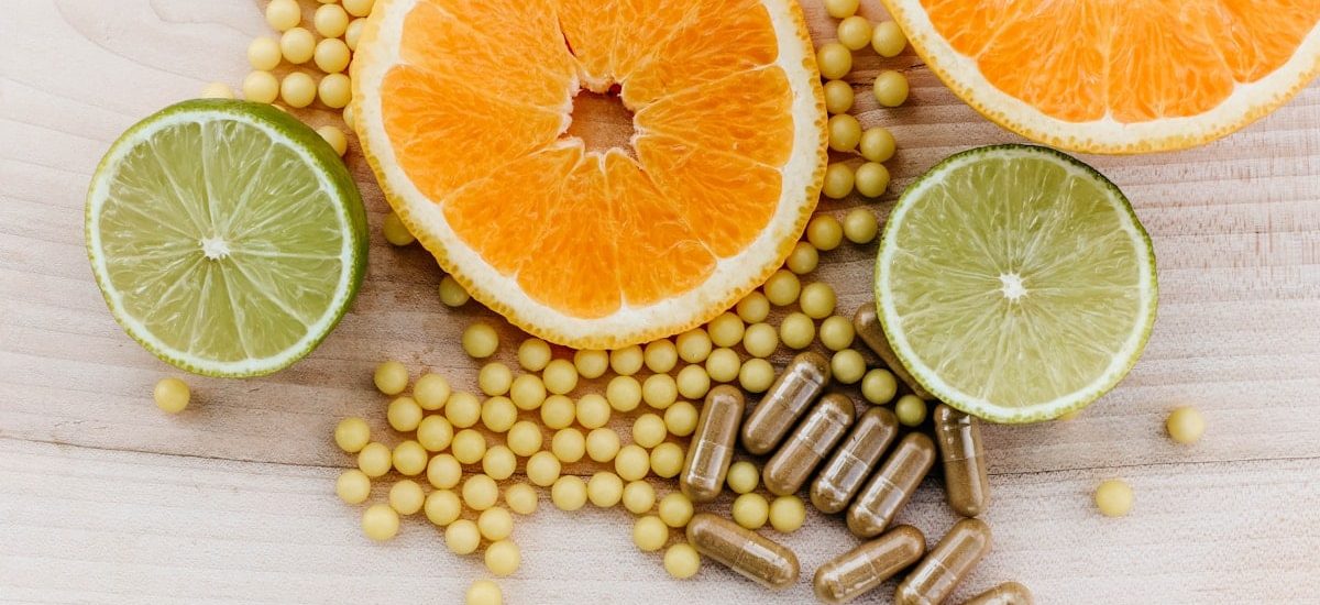 oranges, peas, and limes on a wooden table